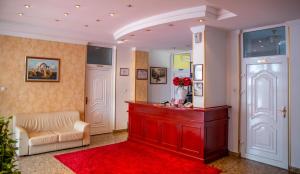 a living room with a red counter and a red rug at Hotel Integra in Doboj