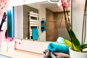 a bathroom with a mirror and a potted plant at Ferienhaus Glücksmoment in Blankenburg +41 photos