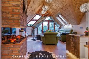 a living room with a brick wall at Polana Szymoszkowa Ski Resort - Chamerion Apartments in Zakopane