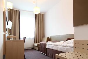 Postel nebo postele na pokoji v ubytování Arche Hotel Siedlce