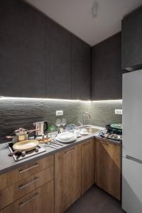a kitchen with wooden cabinets and a counter top at Belly 1 in Vračar (historical) +4 photos