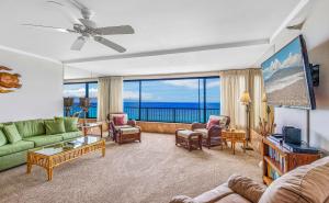 a living room with a view of the ocean at Maui Kai Condos in Lahaina
