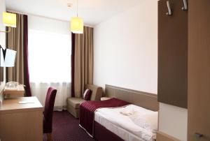 Postel nebo postele na pokoji v ubytování Arche Hotel Siedlce