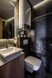 a bathroom with a white sink and a toilet at Belly 1 in Vračar (historical) +4 photos