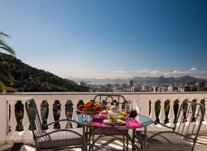 a table with a bowl of fruit on a balcony at Prestige Property - Da Costa in Rio de Janeiro