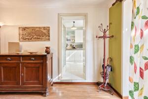 een kamer met een houten dressoir en een spiegel bij Central Apartment in Turijn +32 foto's