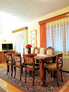 a dining room with a wooden table and chairs at Villa Ευορέων in Pertouli