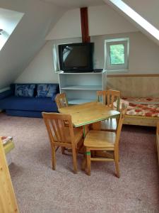 a living room with a table and chairs and a couch at Guest House Kaskáda in Vrané nad Vltavou