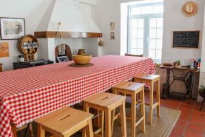 a table with chairs and a red and white checkered table cloth at Jaca Hostel Porto da Cruz in Porto da Cruz