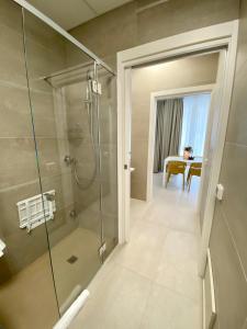 a bathroom with a walk in shower and a glass shower stall at BeeApartments in Bari