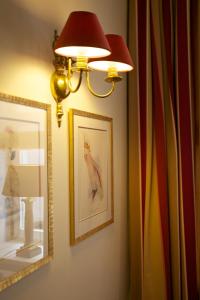 a lamp on a wall with a picture of a bird at Hotel Apia in Vilnius +36 photos