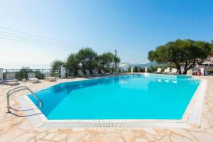 a large swimming pool with blue water at Nissaki Suite Kalypso by Sealand Villas in Nisakion