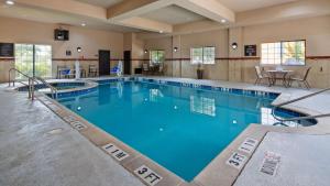 a large swimming pool with blue water at Best Western Plus Mansfield Inn and Suites in Mansfield