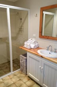 a bathroom with a shower and a sink at William Bay Cottages in Denmark