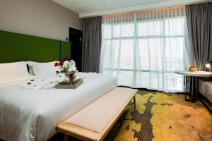 Postel nebo postele na pokoji v ubytování King Park Hotel Kota Kinabalu