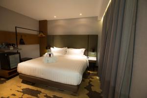 Postel nebo postele na pokoji v ubytování King Park Hotel Kota Kinabalu