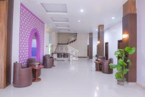 a lobby of a hospital with a purple wall at Super OYO Capital O 1630 Hotel Syariah Ring Road in Banda Aceh