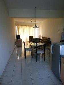 a kitchen and dining room with a table and chairs at Seri Bulan Condo in Port Dickson