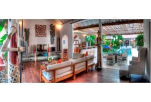 a living room with a couch and a table at Coco Poco Villa Seminyak in Seminyak