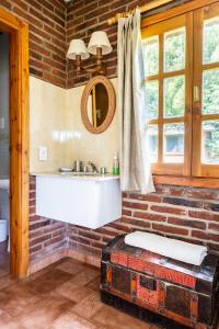 a bathroom with a sink and a mirror at La Cabaña del 5 in San Carlos de Bariloche