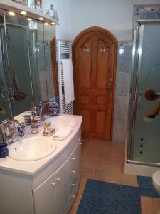 a bathroom with a sink and a shower at Riad Dar Zouhour in Rabat