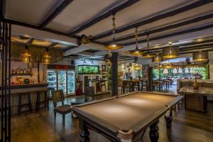 a pool table in a room with a bar at Eden Bungalows Fisherman's village in Bophut