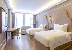 Rúm í herbergi á Mercure Taiyuan E Tech