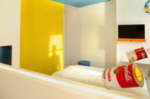 a cocacola bottle sitting on a shelf in a room at Georgette Hôtel & Restaurant in Paris