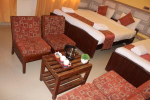 מיטה או מיטות בחדר ב-Kaveri Hotel Bed & Breakfast