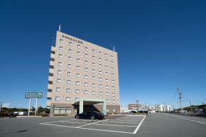 Ōka的住宿－Hotel Econo Taki，停车场内有停车位的建筑物