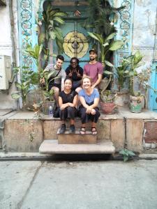 a group of people sitting in front of a building at The Desire Hostel in New Delhi