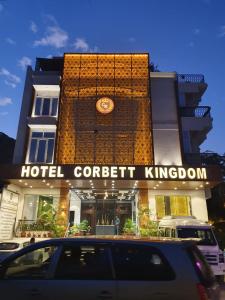 a hotel coefficient kingdom building with a clock on it at Hotel Corbett Kingdom in Rāmnagar
