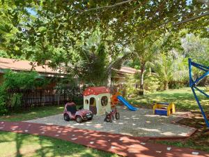 a playground with a toy car and a play structure at Isla de Paz Beach Resort in Siquijor