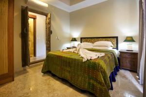 een slaapkamer met een bed met een groene sprei bij Bayshore Residence in Candidasa