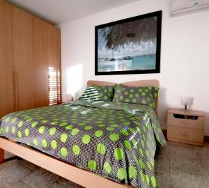 a bedroom with a bed with a polka dot bedspread at Affitti Brevi- MEDITERRANEO in Crotone +5 photos