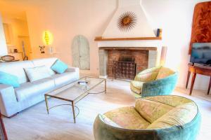 a living room with a couch and a fireplace at Les Remparts Antibes Location in Antibes
