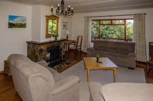 a living room with two couches and a fireplace at The Volmoed Trust in Hermanus