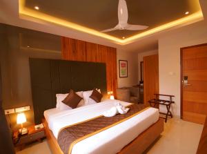 A bed or beds in a room at WithInn Hotel - Kannur Airport