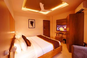 A bed or beds in a room at WithInn Hotel - Kannur Airport