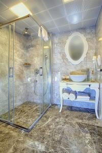 a bathroom with a shower and a sink at Güvenay Business Hotel in Ankara