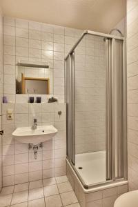 a bathroom with a sink and a shower at Landhotel Donaublick in Obernzell