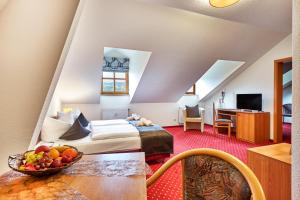 a hotel room with a bed and a table at Landhotel Donaublick in Obernzell