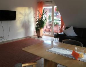 a living room with a table and a couch at Ferienwohnung Haus Albsicht in Mössingen