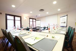 a conference room with a long table with chairs at Kyriad Direct Marseille Ouest - Martigues in Martigues
