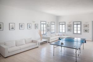 a living room with white couches and a table at Paros Philoxenia in Chrissi Akti