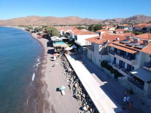an aerial view of a beach with umbrellas and buildings at Hotel Kyma in Skala Eresou