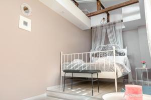 a bedroom with a white bed and a chair at The Red Roof House in Plovdiv
