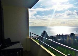 a room with a balcony with a view of the ocean at Vier Jahreszeiten Haus 2 Whg 73 in Großenbrode
