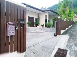 a house with a mailbox next to a fence at ViewPoint Villa in Kathu