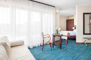 a hotel room with a table and a bed at Hotel Bonum Old Town in Gdańsk